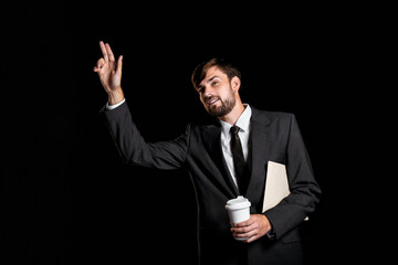 Handsome businessman on black background