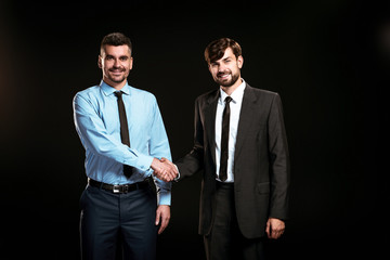 Handsome businessmen on black background