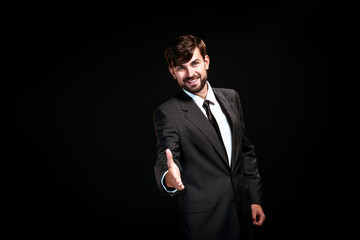 Handsome businessman on black background