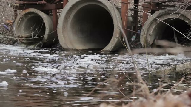 Dirty water  flows from a pipe