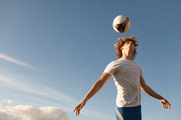 Soccer player hitting the ball with his head. 