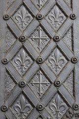 Metal ornamental door with cross and fleur de lis