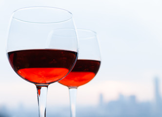Pair of red wine glasses in a high rise restaurant. 