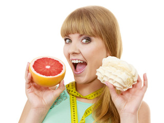 Woman choosing fruit or cake make dietary choice