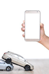 woman hands use cell phone with miniature car, insurance concept