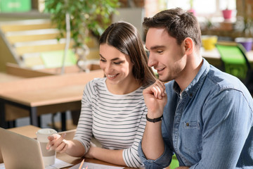 Positive colleagues using laptop