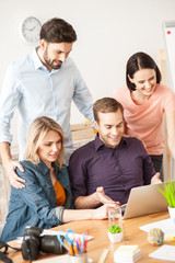 Cheerful young freelancers are using a computer