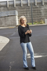 Woman in Black Top Texting on Cell Phone