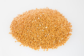 Heap of millet groats on white