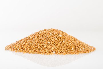 Heap of millet groats on white