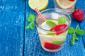Strawberry mint homemade lemonade on blue wooden table