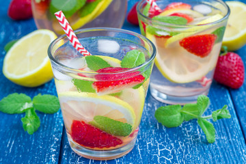 Strawberry mint homemade lemonade on blue wooden table