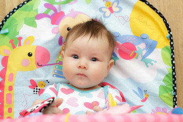 Happy little newborn baby with toys 