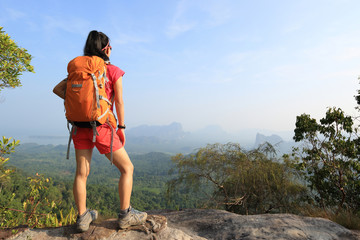 young woman hiker enjoy the view on seaside mountain top