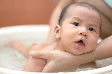 Asian baby bathing