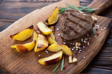 Grilled fillet mignon beefsteak with roasted potato wedges