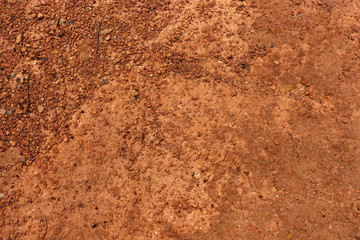 Dry red soil and small rock in Thailand.