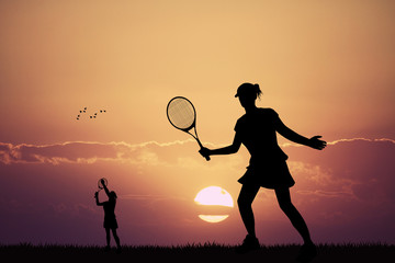 girl playing tennis at sunset