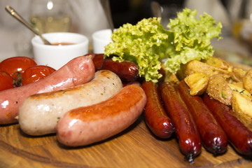 Many different fried sausages with salad