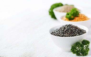Bowls of assorted dried lentils with red lentils, black beluga l