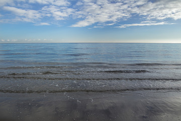 Fototapeta na wymiar Seascape with stratocumulus clouds over sea horizon line