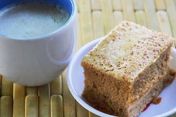 cake and milk coffee on bamboo plate