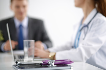 Medical team sitting at the table in modern hospital