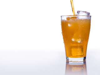 Pooring soft drink in a glass with ice