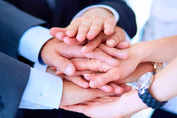 Business people with their hands together in a circle