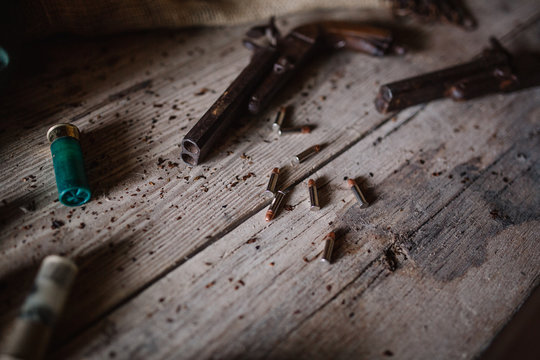 Closeup of a rifle on a wood