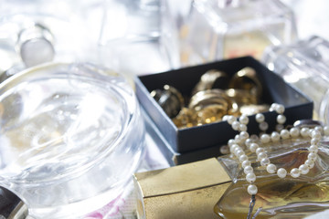 pearl necklace on perfume bottle and family jewels