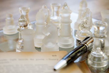 roller pen old book and glass chessboard