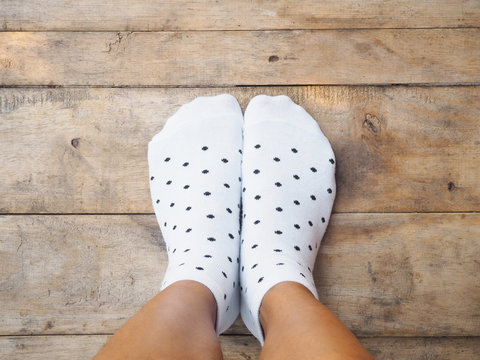  feet wearing white polka dot socks