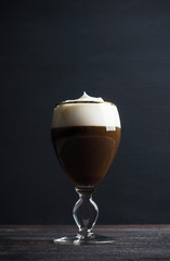 Irish coffe on the dark wooden background