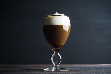 Irish coffe on the dark wooden background