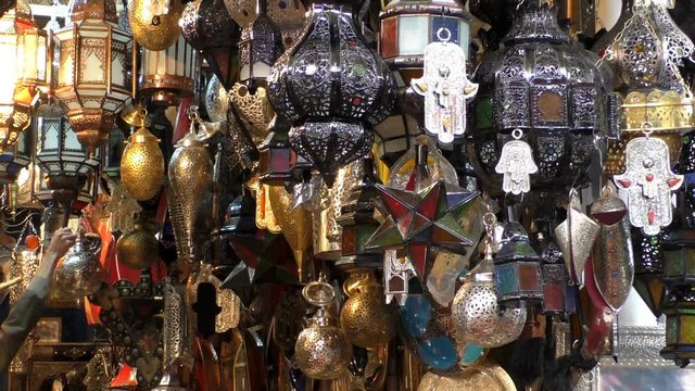 Traditional metal and glass artisan crafted electric and candle lights and lanterns for sale at the Marrakesh Marrakech market or souk in Morocco