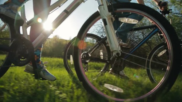 Steadicam shot of healthy man and woman pedaling fast.