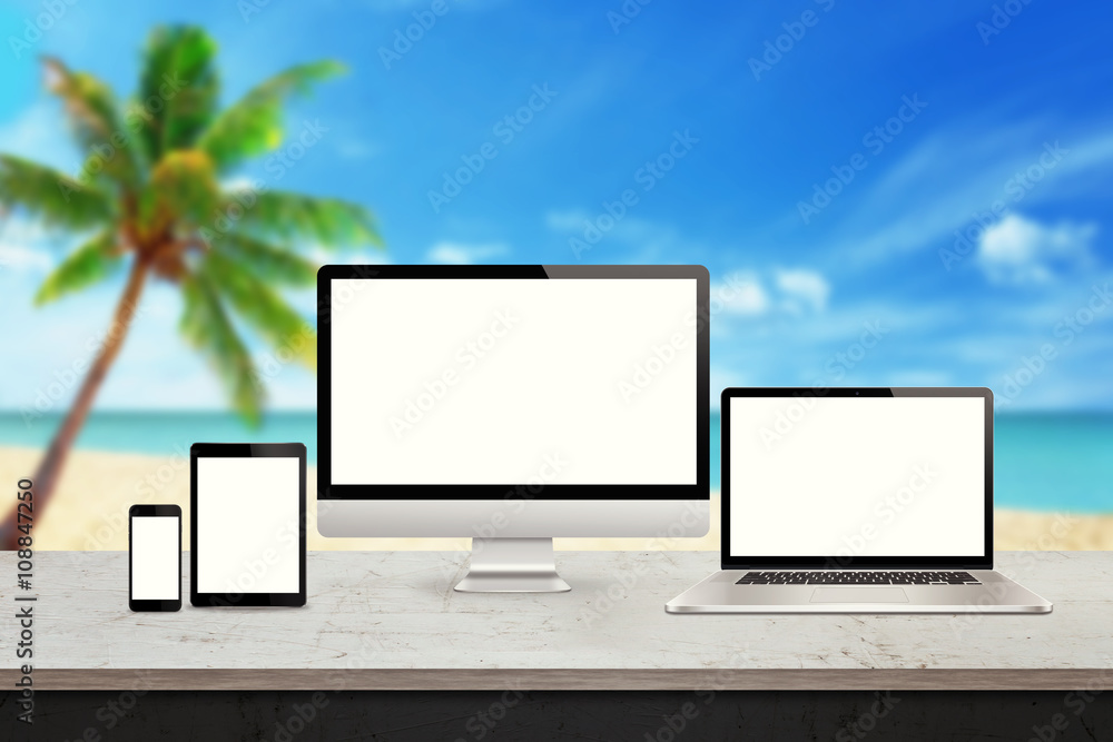 Poster Computer display, laptop, tablet and smart phone responsive display devices on table. Isolated white screen for mockup presentation. Summer beach in background