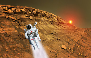 Astronaut spaceman suit planet Mars jet pack jetpack space landscape. Elements of this image furnished by NASA.