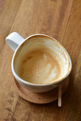 cup of espresso coffee with wooden table background