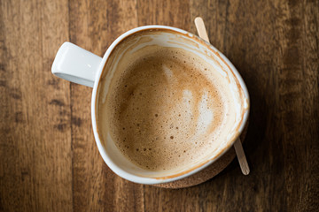 cup of espresso coffee with wooden table background