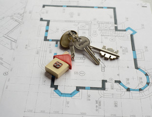 Closeup of keys on blueprint of new home. copy space