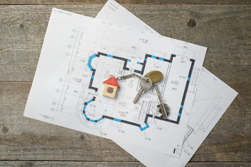 Closeup of keys on blueprint of new home. copy space