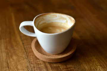 cup of espresso coffee with wooden table background