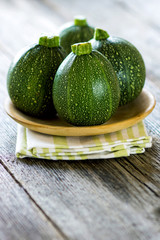 Round zucchini  on wooden background