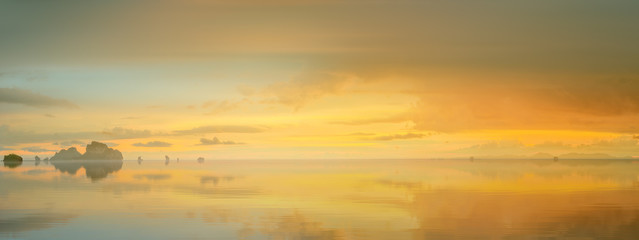 sunset with colorful sky and boat on the beach