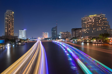 River view with the lights, boats and modern buildings at night,