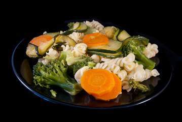 Italian pasta girandole with broccoli, zucchini and carrot