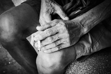 Closeup hand old man hold smoke,black and white tone