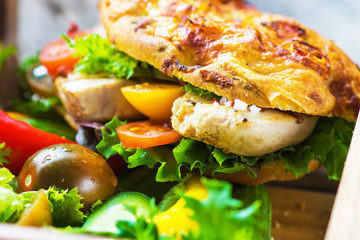 Delicious sandwich with grilled chicken and fresh crunchy vegetables 
